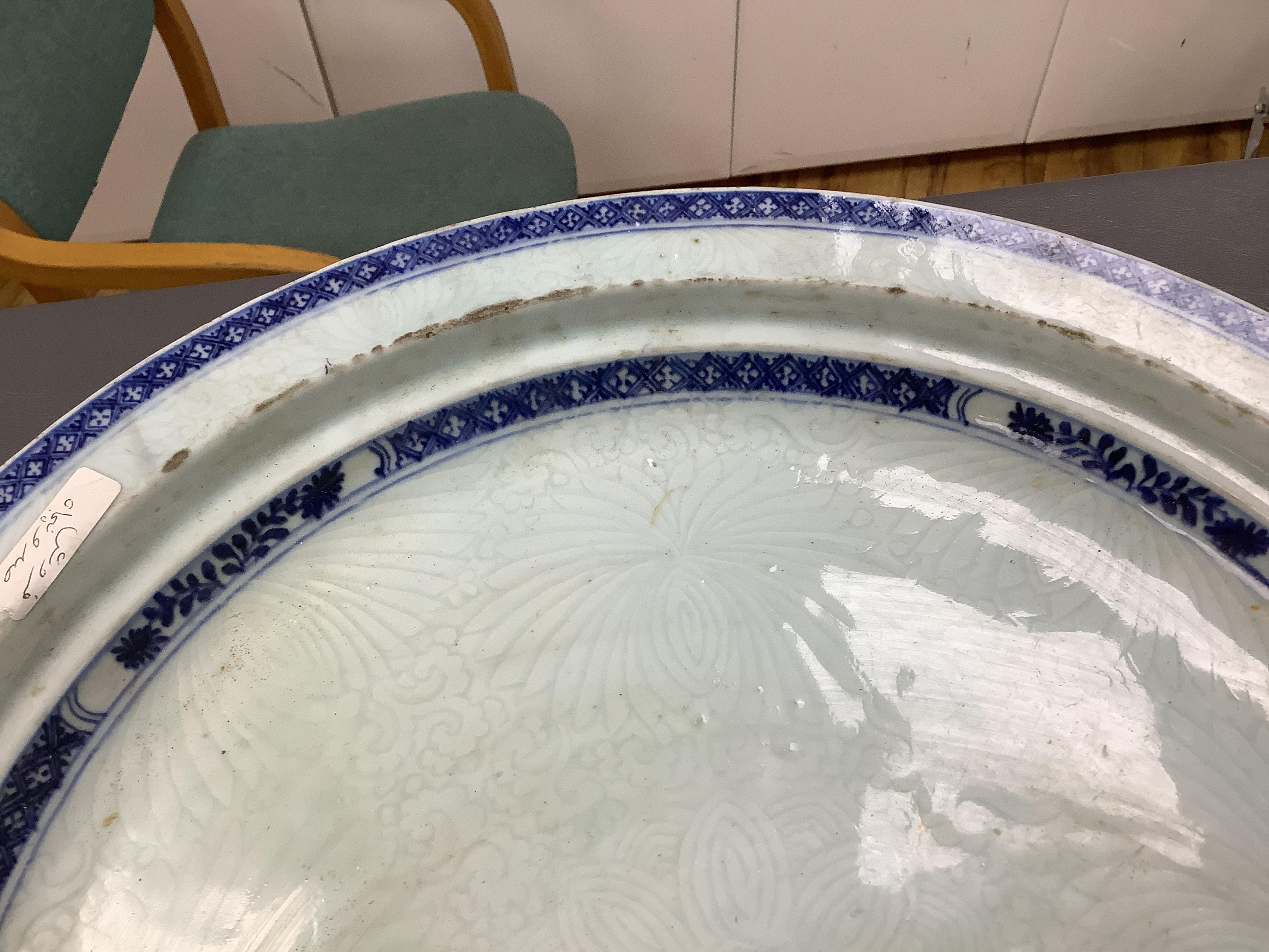 An 18th century Chinese export blue and white chrysanthemum moulded dish, 42cm